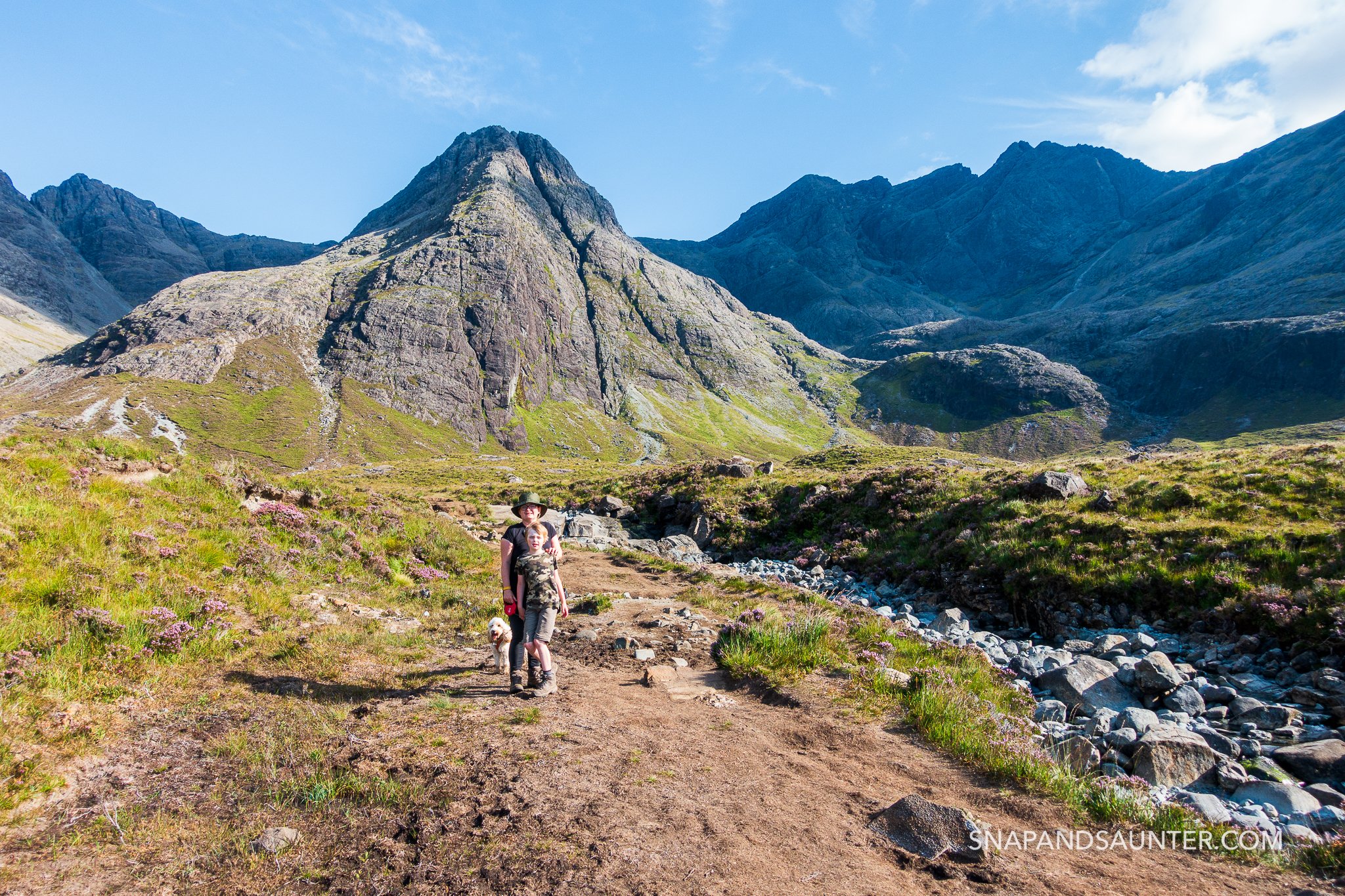 A boy standing infront of Sgurr an Fheadain at Fairy Pools on the Isle of Skye