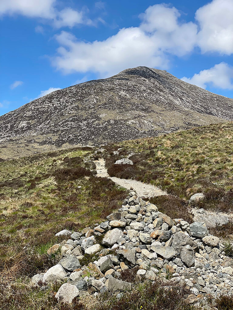 stones in the foreground, path to the Goatfell Mountain in Scotland